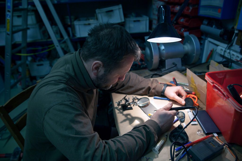 A man works with a soldering iron