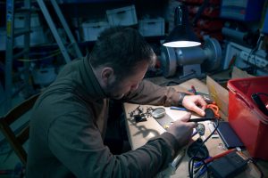 A man works with a soldering iron